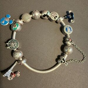 Disney Parks Pandora charm bracelet with Disney Parks beads and extras.
